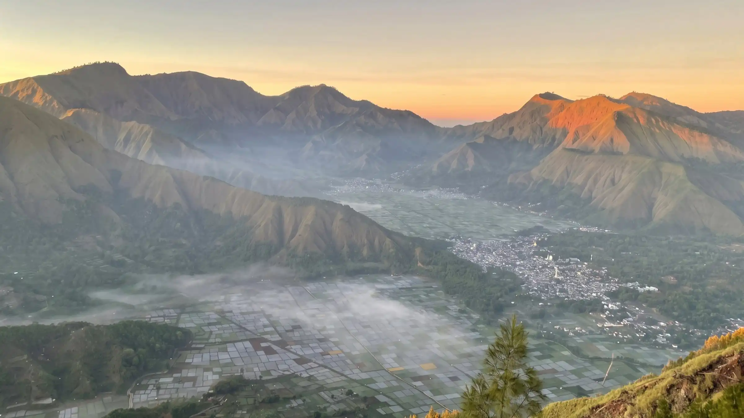 View over Sembalun village and patchwork fields from Pergasingan Hill at sunrise